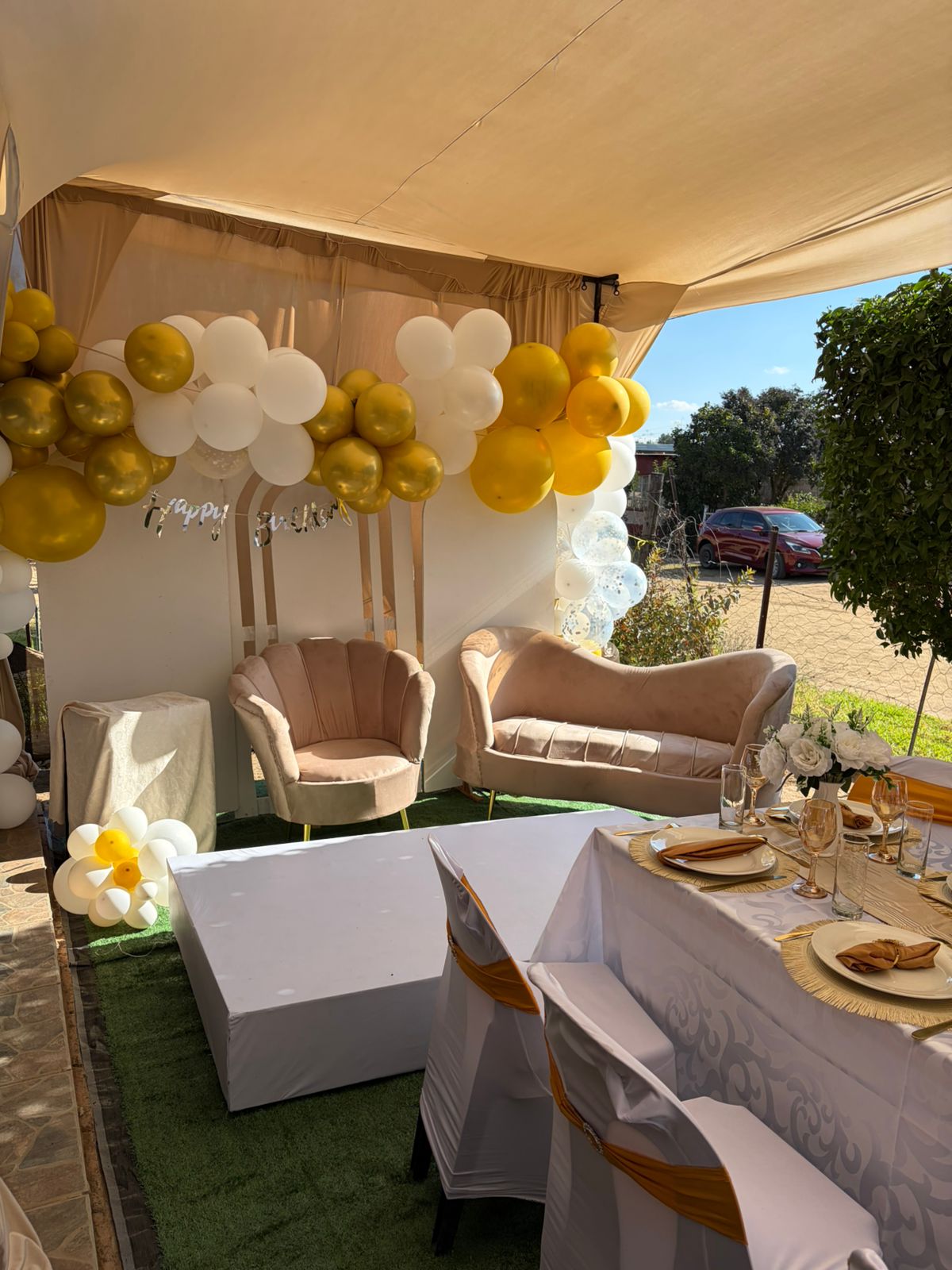 Sisterly Touch lounge and balloon setup in gold, ivory, and champagne.